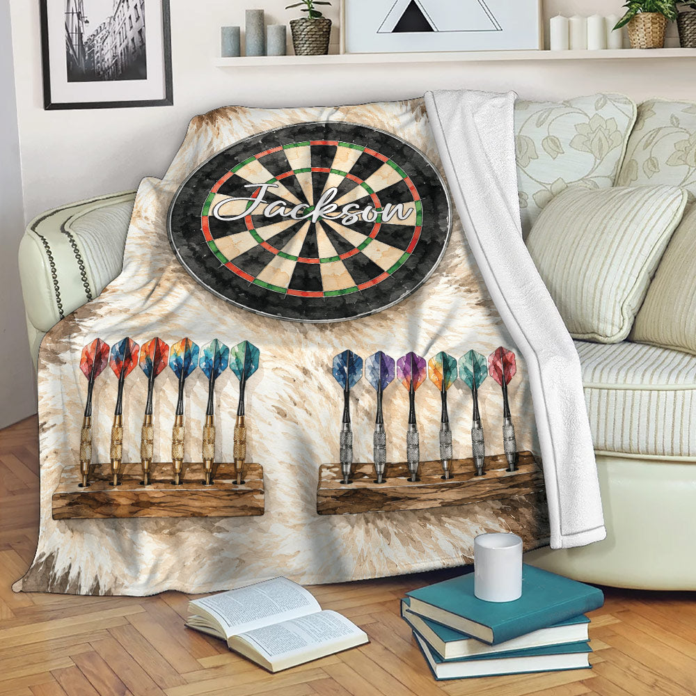 Dart board throw blanket displayed on a sofa with a rustic dartboard and colorful dart design