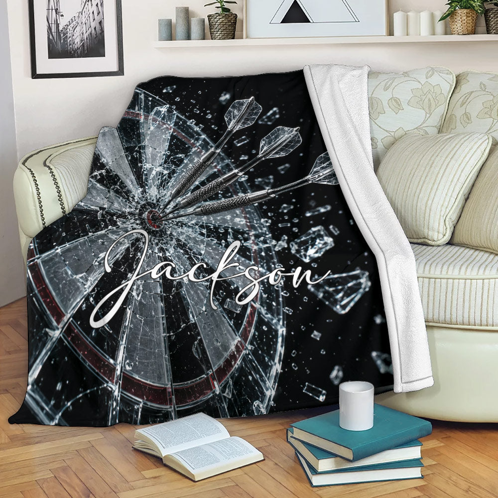 Dart Board Throw Blanket draped over a sofa with shattered target and dart artwork