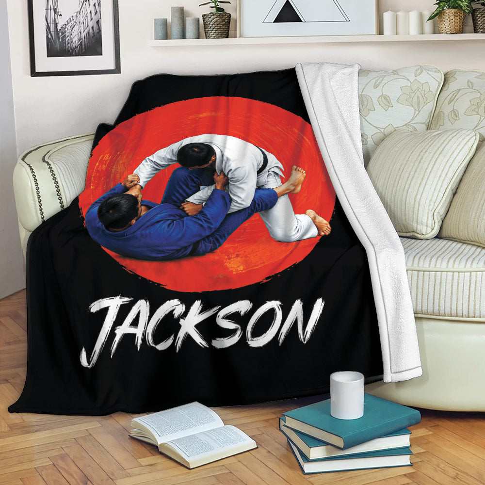 Jiu Jitsu blanket displayed on a sofa with bold red and black grappling artwork