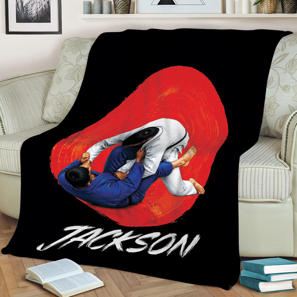 Black Jiu Jitsu throw blanket draped over a couch with dynamic grappling artwork