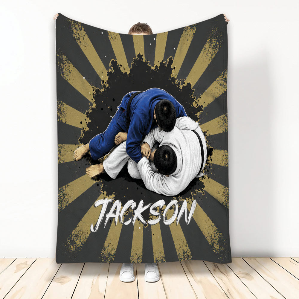 Jiu Jitsu throw blanket featuring two grapplers in blue and white gis with bold black and gold artwork