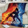 Jiu Jitsu throw blanket draped over a couch featuring two grapplers and bold fiery colors