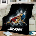 Wrestling throw blanket draped over a sofa, featuring two athletes in an intense match