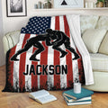 Wrestling throw blanket displayed across a couch with grappler artwork and distressed American flag graphics