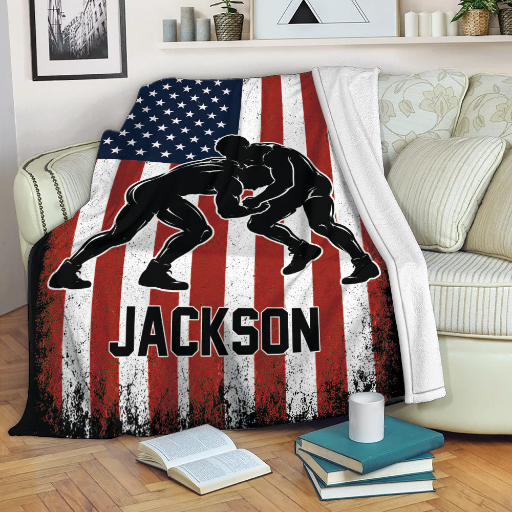 Wrestling throw blanket displayed across a couch with grappler artwork and distressed American flag graphics