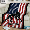 Wrestling blanket draped over a sofa, featuring two grapplers and bold red, white, and blue artwork