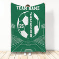 Green soccer blanket displayed upright with bold soccer ball artwork, stadium lights and goal field