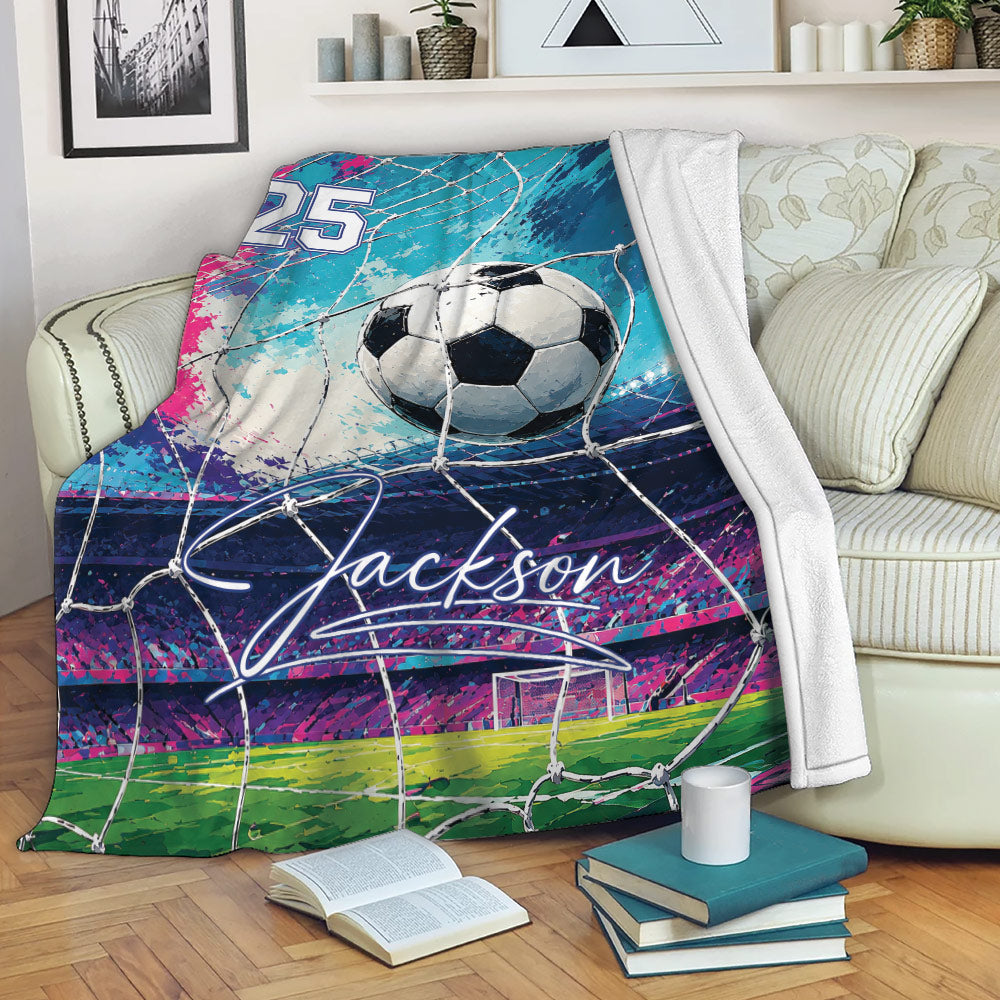 Soccer blanket draped over a sofa with goal net artwork, colorful stadium graphics, and cozy living room setting