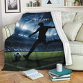 Soccer blanket draped over a sofa with stadium artwork, field, and silhouetted player