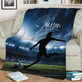 Soccer throw blanket displayed on a couch with dramatic stadium lights and player artwork