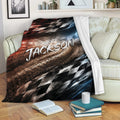 Custom racing blanket draped over a sofa with dynamic racetrack graphics and checkered flag details