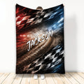 Racing throw blanket with dramatic racetrack artwork, checkered flags, and red, black, and blue accents