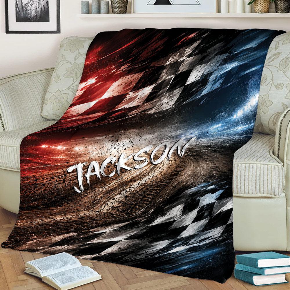 Racing throw blanket displayed on a couch with illuminated track artwork and bold checkered patterns