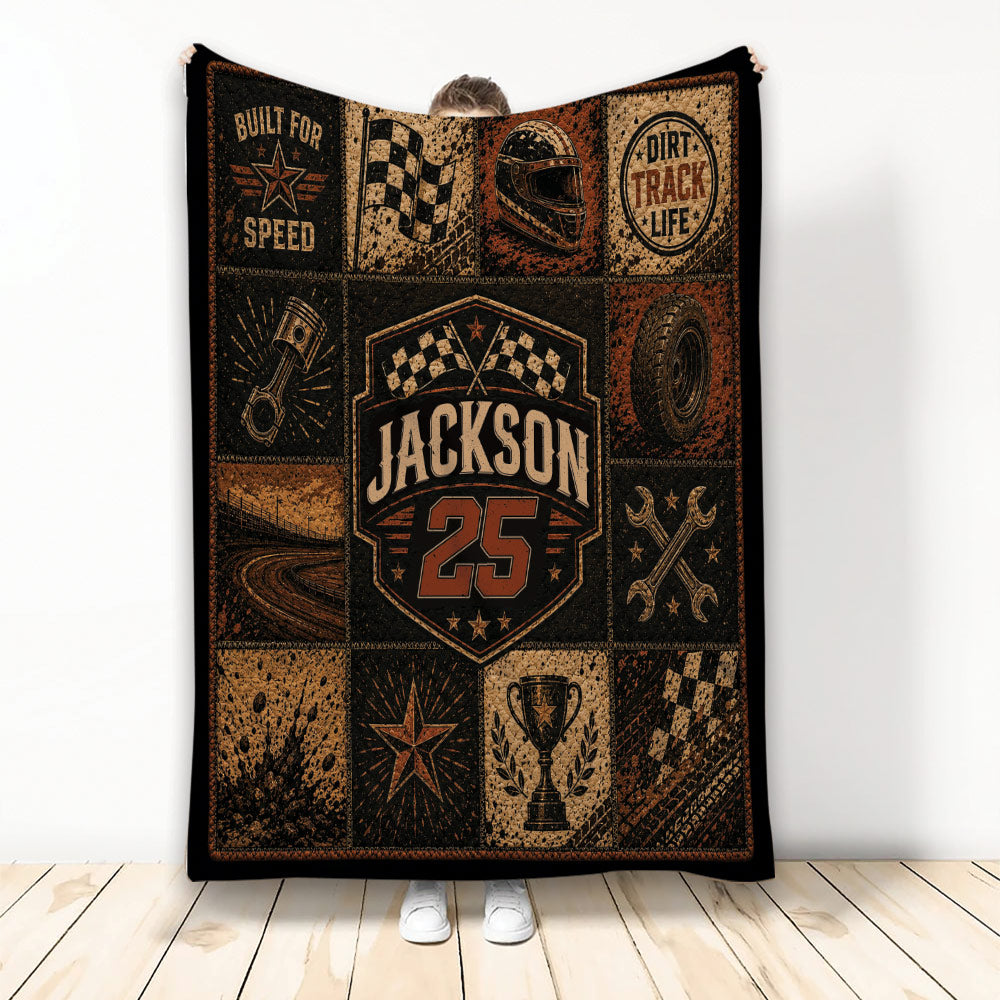 Dirt track racing blanket with checkered flags, racing helmet, tires, trophy, and rugged vintage motorsport artwork