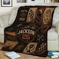 Dirt track racing blanket displayed on a sofa with vintage racing graphics, track imagery, and trophy artwork