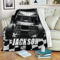 Dirt track racing blanket draped over a sofa, featuring a black and white sprint car and racing artwork