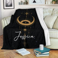 Wicca throw blanket draped over a sofa with golden lunar symbols and starry celestial artwork