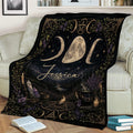 Wicca throw blanket draped over a sofa with lunar symbols, crystals, candles, and cauldron artwork
