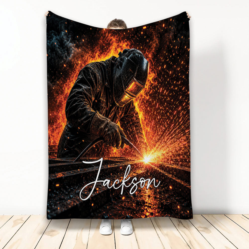 Welder throw blanket featuring a protective-gear welder surrounded by fiery orange welding sparks