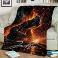 Welder throw blanket displayed across a couch with a dramatic black, orange and blue welding scene