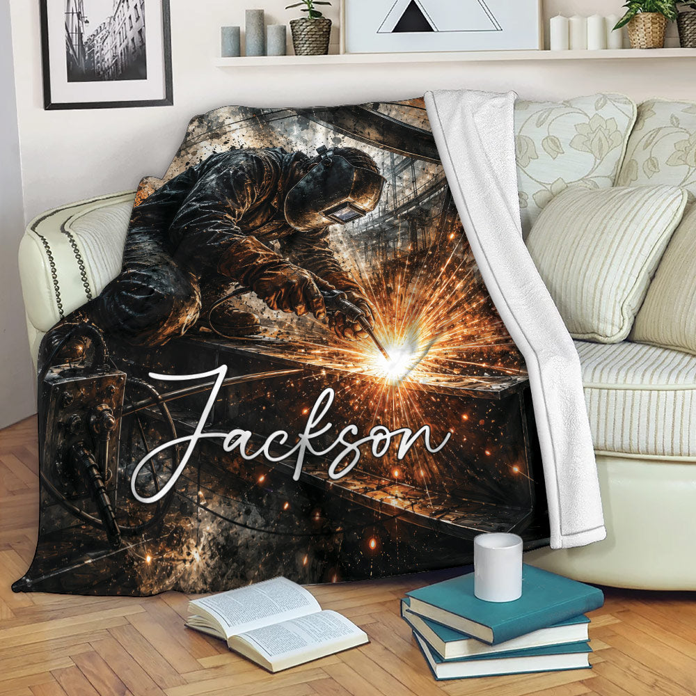 Welder throw blanket draped over a sofa, featuring dramatic welding sparks and dark industrial artwork