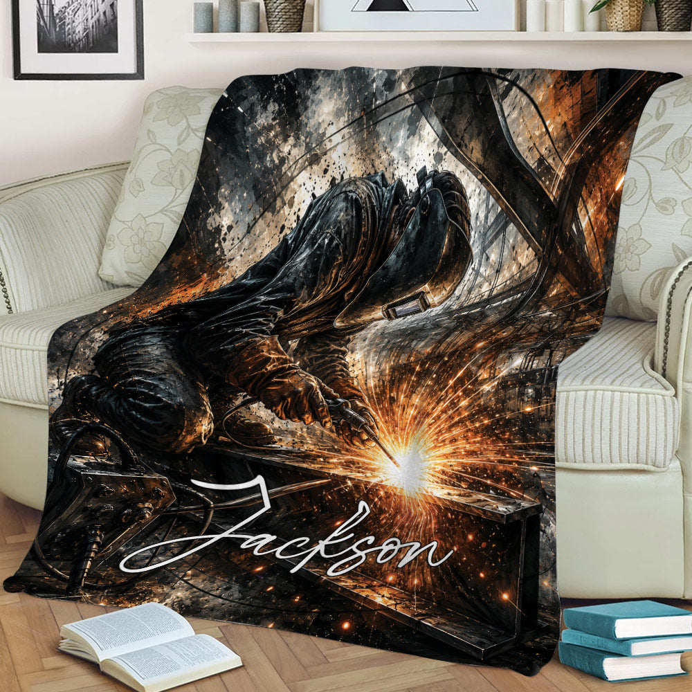 Close lifestyle view of a welder blanket on a sofa with a helmeted worker and bright welding sparks
