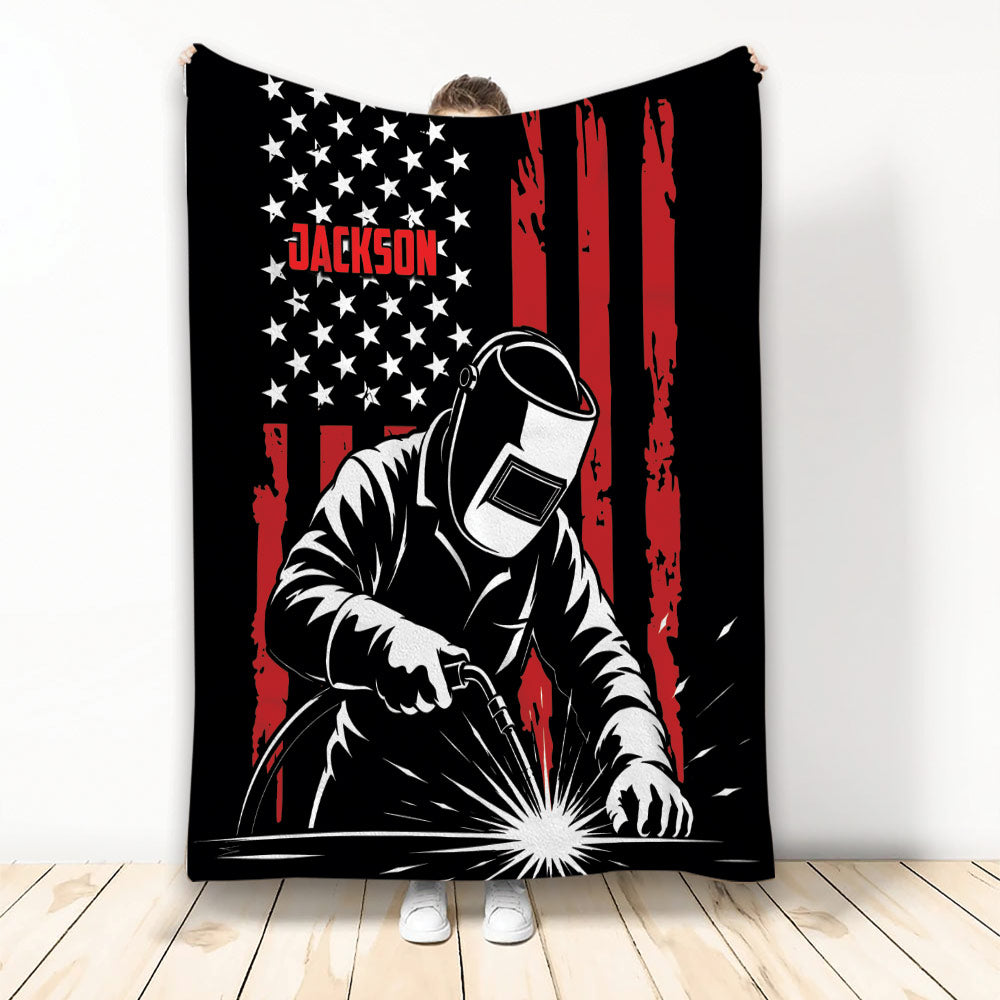 Welder throw blanket featuring a helmeted worker, welding sparks, and bold black, red, and white artwork