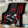Welder throw blanket displayed on a couch with dramatic welding sparks and bold graphic artwork