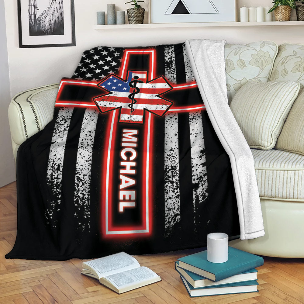 Paramedic throw blanket displayed on a sofa with patriotic Star of Life artwork and bold emergency service styling