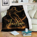 Black and gold lacrosse throw blanket styled on a living room sofa