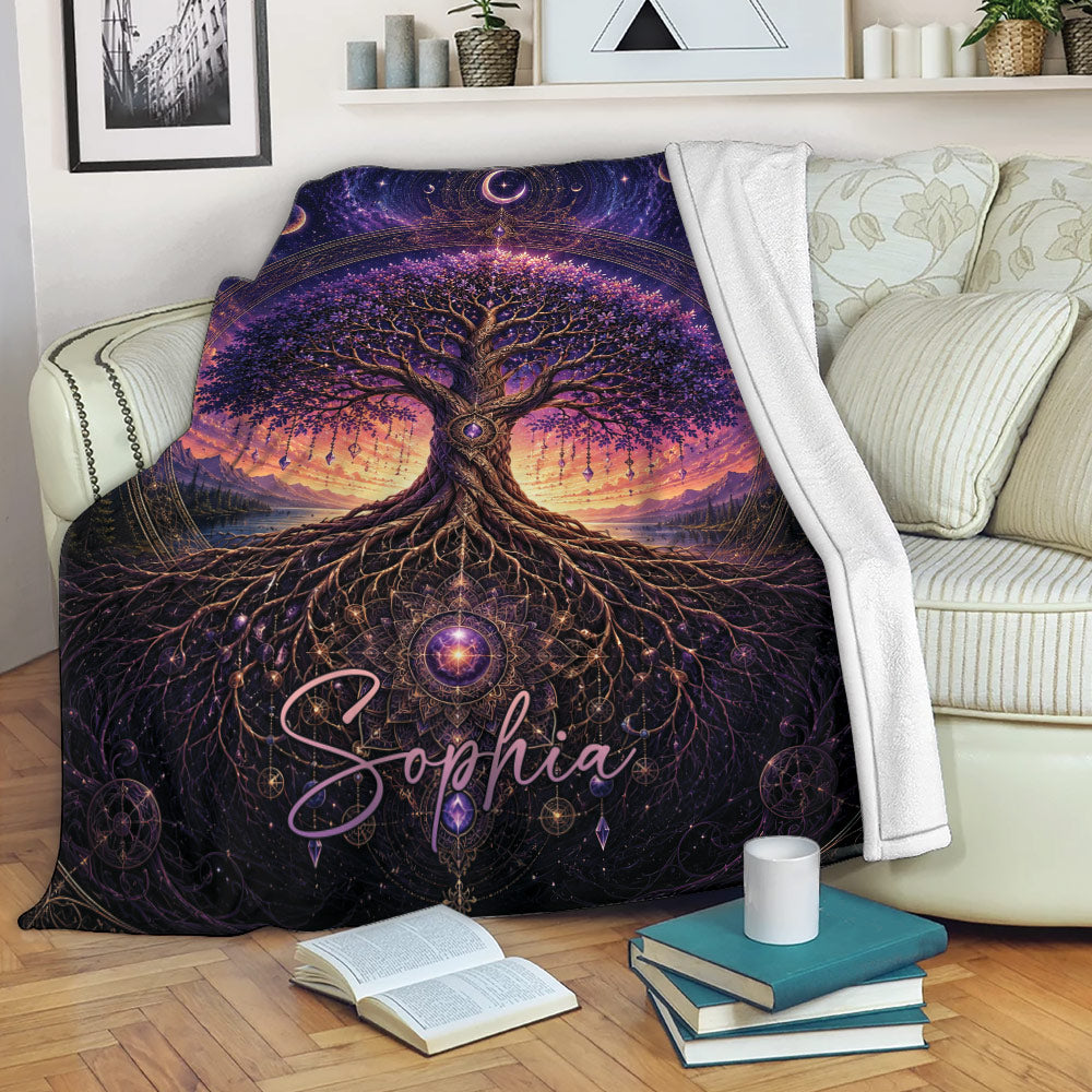 Tree of Life throw blanket displayed on a sofa with purple cosmic artwork and sunset mountain scenery