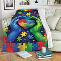 Colorful Autism blanket draped over a sofa with puzzle piece and heart design