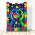 Autism throw blanket with colorful puzzle pieces, heart artwork, and supportive hands