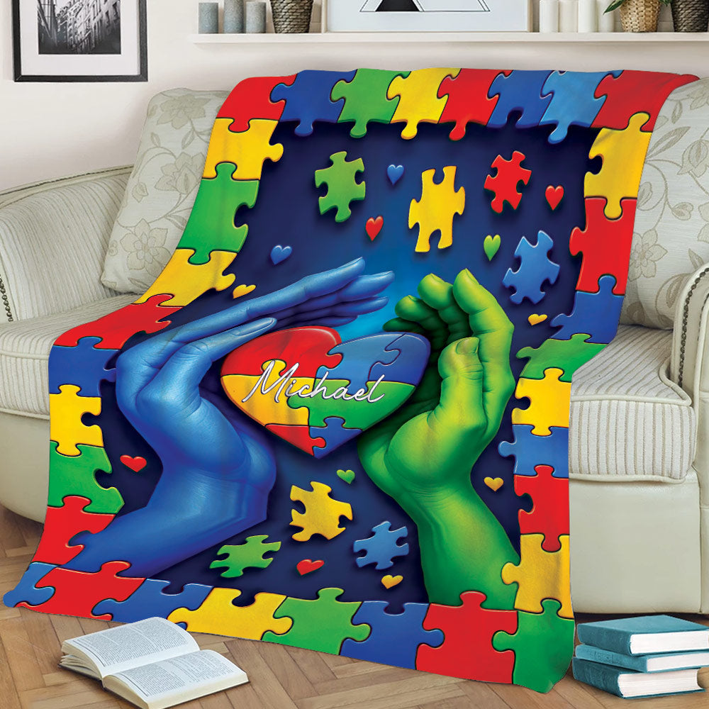 Autism throw blanket displayed on a couch with vibrant puzzle pieces and heart artwork