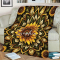 Sunflower throw blanket draped over a couch with dramatic floral and leafy mandala design