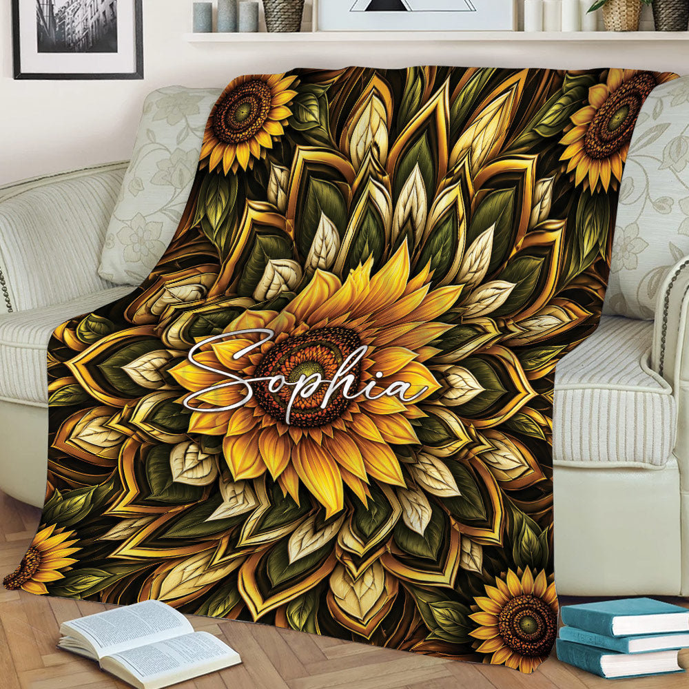 Sunflower throw blanket draped over a couch with dramatic floral and leafy mandala design