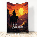 Cowboy throw blanket with horseback rider, mountain valley, glowing sunset, and western landscape artwork