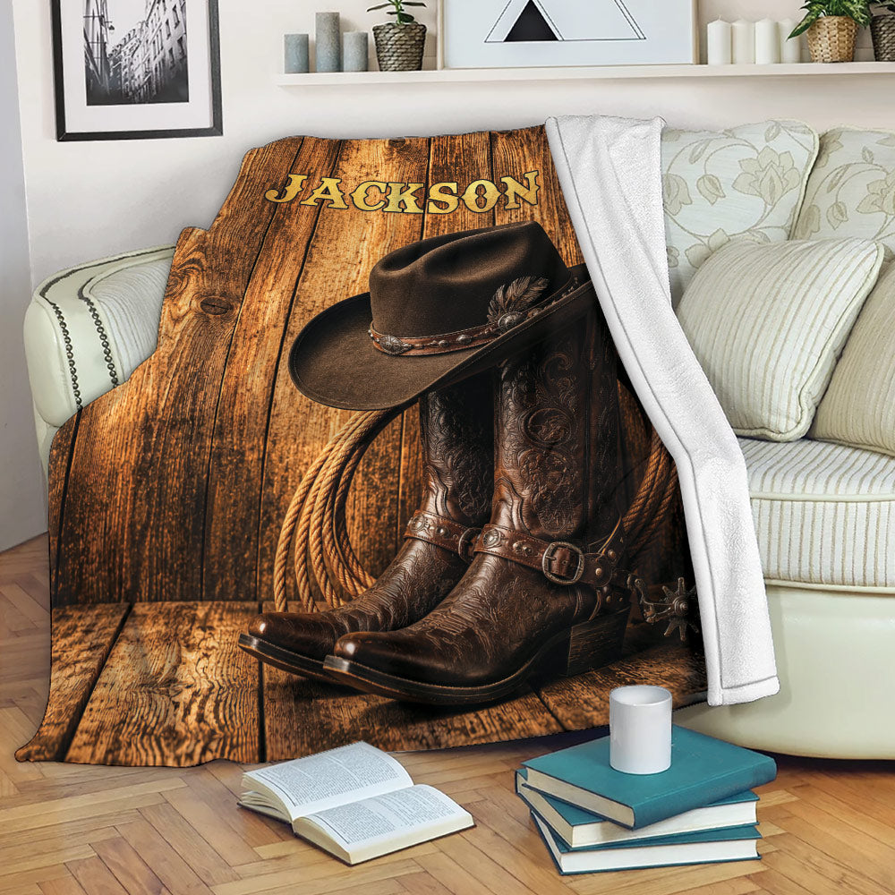 Western cowboy throw blanket displayed on a sofa with hat, boots, rope, and wood plank design
