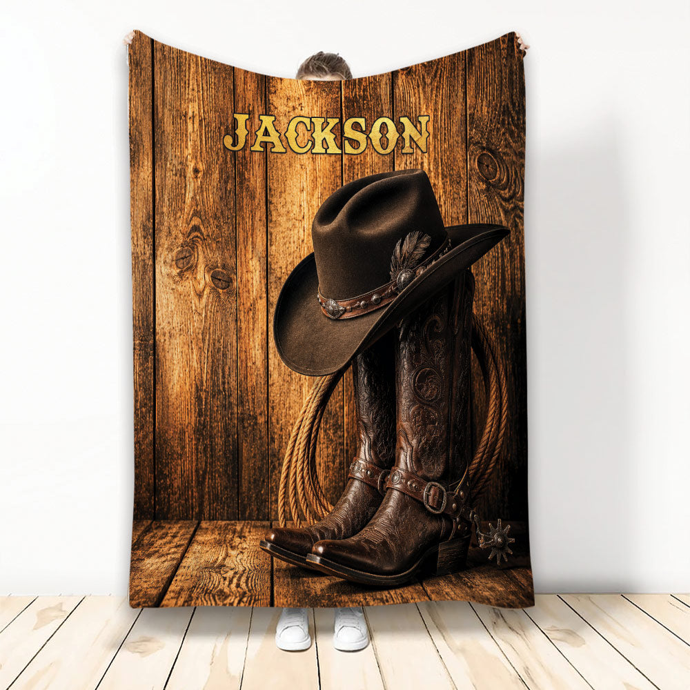Custom cowboy blanket featuring a western hat, leather boots, rope, and rustic wood artwork