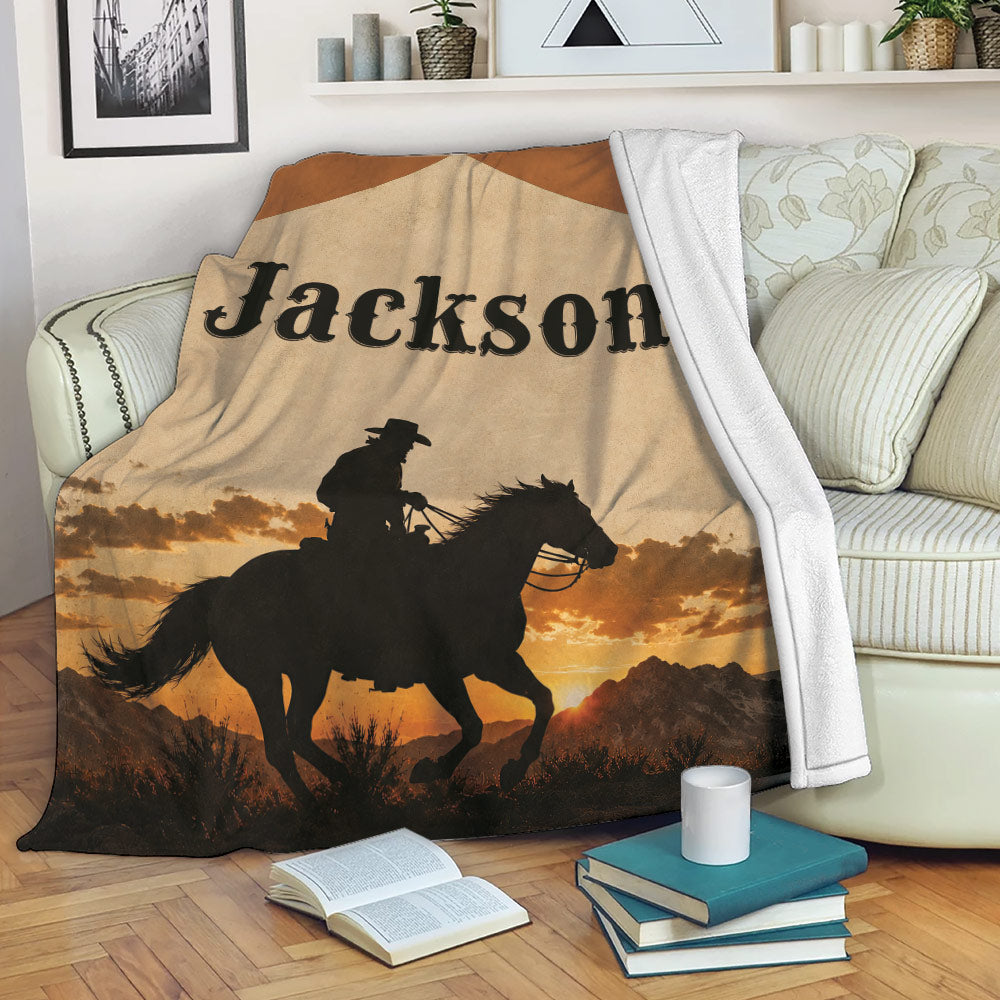 Western cowboy blanket draped over a sofa with horseback rider and sunset landscape design
