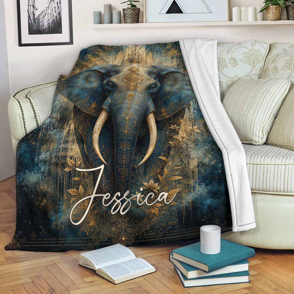 Blue and gold elephant throw blanket styled on a living room sofa