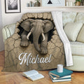 Elephant throw blanket displayed on a sofa with cracked earth artwork and wildlife decor