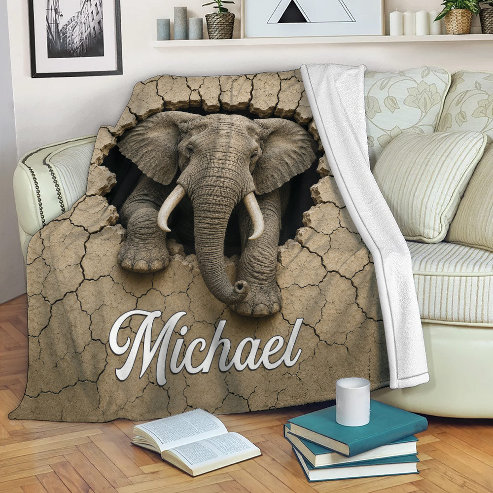 Elephant throw blanket displayed on a sofa with cracked earth artwork and wildlife decor