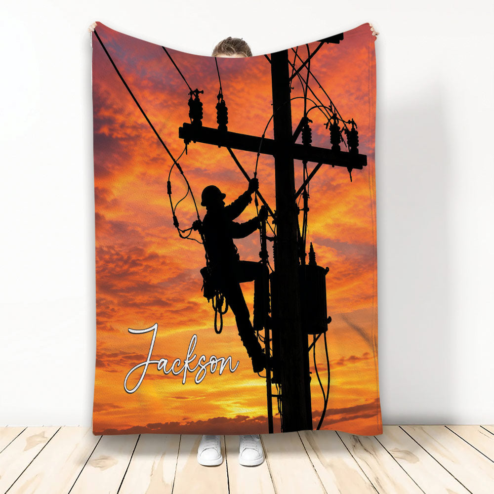 Lineman throw blanket featuring a utility worker silhouette on a power pole against a vivid orange sunset