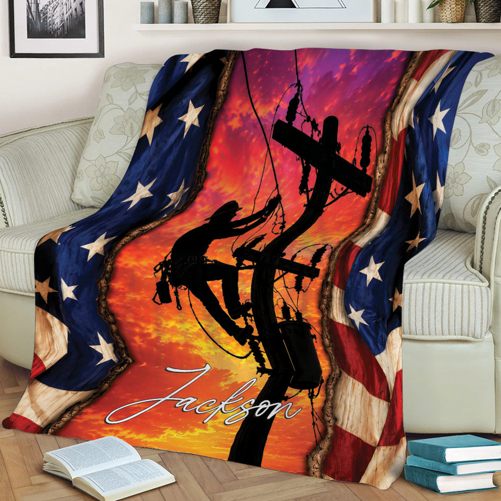 Lineman throw blanket displayed on a couch with electrical line worker silhouette and patriotic flag artwork