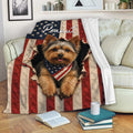 Yorkshire Terrier throw blanket displayed on a sofa with patriotic flag artwork and a cozy living room setting
