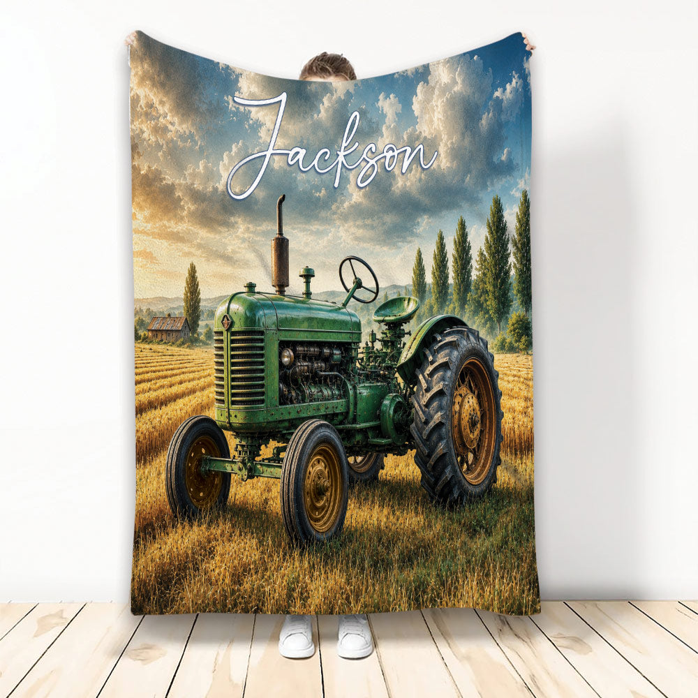 Green tractor throw blanket displayed against a rustic farm field and dramatic blue sky