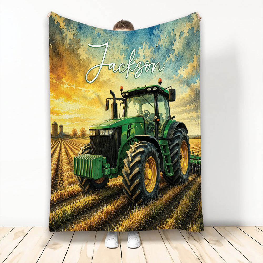 Tractor blanket displayed upright with a green farm tractor, golden field, and dramatic blue and gold sky