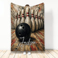 Bowling blanket featuring a black bowling ball, arranged pins, and bold distressed alley artwork