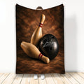 Bowling throw blanket featuring wooden pins and a black bowling ball on a rich brown textured background